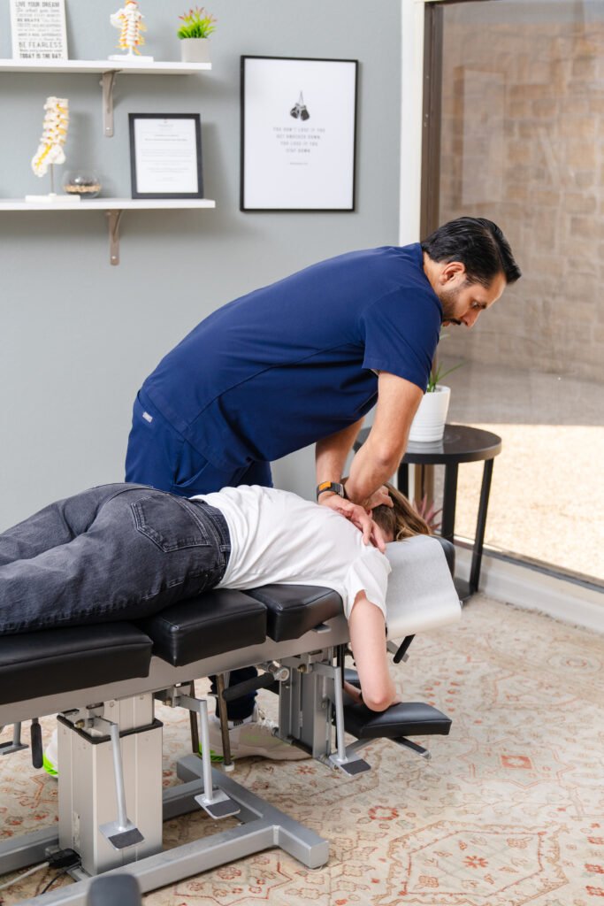 Chiropractor performing a spinal adjustment