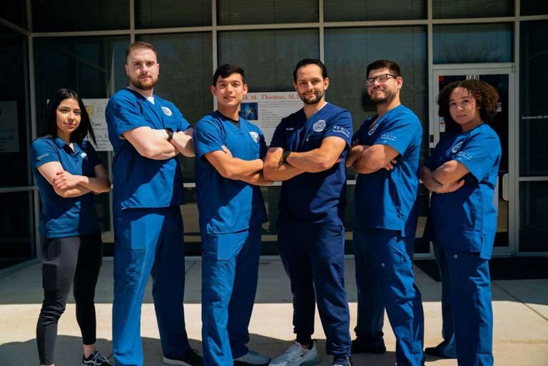 The chiropractic care team at ZENITH Injury Relief & Wellness Clinic standing together in uniform